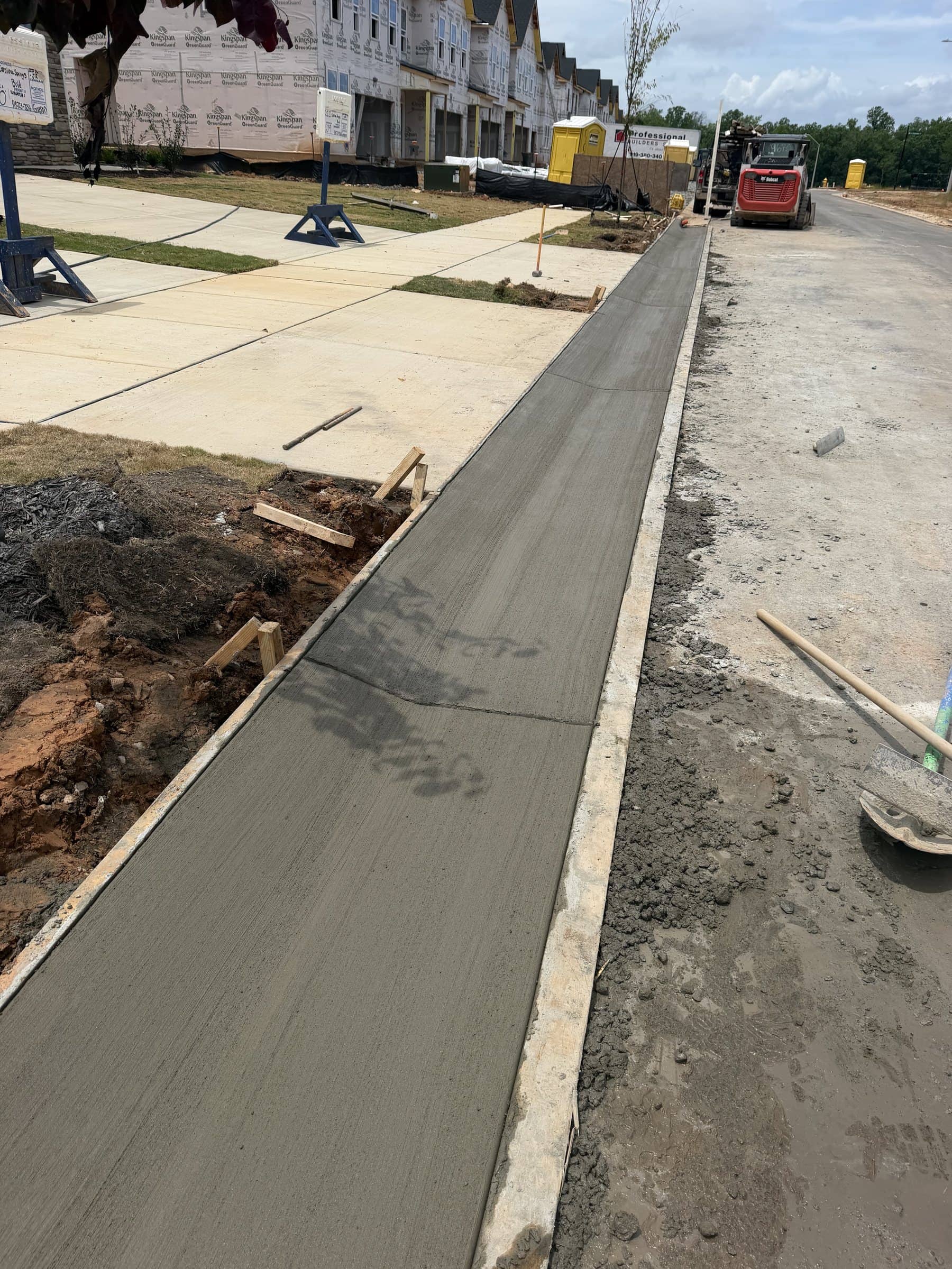 Fresh sidewalk along a townhome street